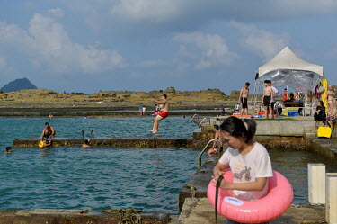 People enjoying a dip in protected seawater pools at Heping Island Park on Taiwan's northeast coast.