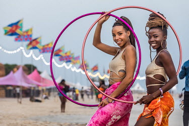 Festival-goers relax on the sand during the Afronation Ghana 2019 beach music festival on Laboma beach.