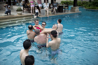 Members of Diamond Love, a high-end dating service, take part in pool games during a weekend retreat where men and women spend time meeting and getting to know prospective partners.