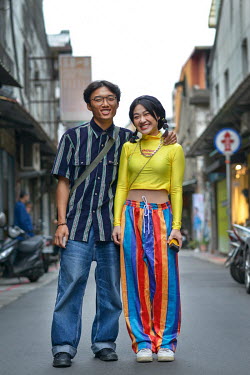 TAIWAN, Taipei: Taiwanese visitors Yang Yueh-wei(24, left) and Ho Yi-ting (22) enjoy the bohemian atmosphere of Taipei's Chifeng Street.