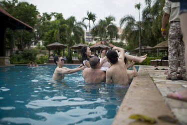 Members of Diamond Love, a high-end dating service, take part in pool games during a weekend retreat where men and women spend time meeting and getting to know prospective partners.