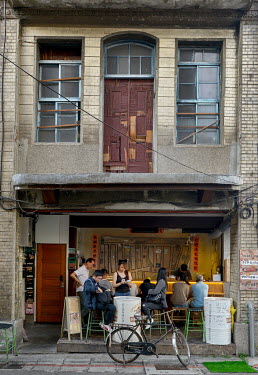 The facade of traditional shophouse, with a popular cafe open to the street on the ground floor, in a lane off of Chifeng Street.