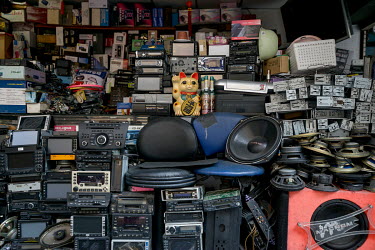 Numereous old devices stacked up outside an electronics workshop on Chifeng Street.