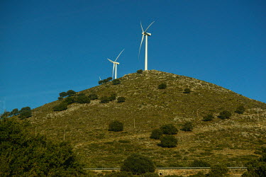 Wind turbines atop a hill, seen from the train approaching Ronda.