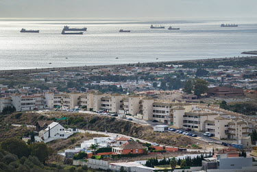 Shipping moored in the Strait of Gibraltar and a housing development in the foreground.