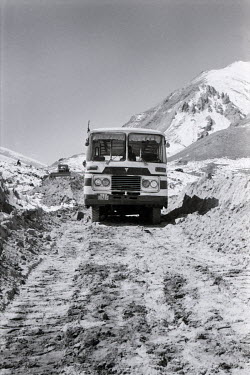 A passenger bus from Pirali, on the Pakistan/China border, travelling to Kashgar negotiates the still-under-construction Karakoram Highway.