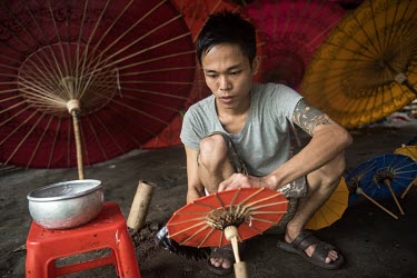 A traditiona umbrella maker at work in his studio.