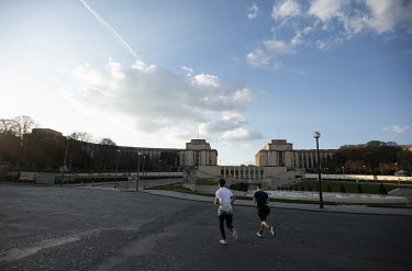 Joggers crossing a deserted Trocadero. In response to the global spread of the novel COVID-19 virus, the French government has imposed severe measures to stem the propagation of the coronavirus. Schoo...