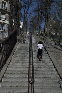 Residents jogging and exercising up and down the iconic steps of Montmartre. In response to the global spread of the novel COVID-19 virus, the French government has imposed severe measures to stem the...