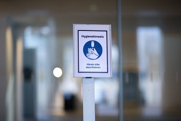 A sign asking people to wash their hands at the entrance to the Chancellor's office.