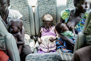 The day after their arrival to Uganda the Monday family is transported in a bus that takes them to the larger refugee centre in Kuluba. On the backseat is Farida Aba, 6, who has a high fever because o...
