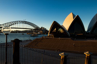 The area around the Sydney Opera House and Sydney Harbour Bridge stand almost deserted as people heed advice to avoid public places and tourist attractions.
