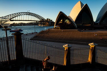 The area around the Sydney Opera House and Sydney Harbour Bridge stand almost deserted as people heed advice to avoid public places and tourist attractions.