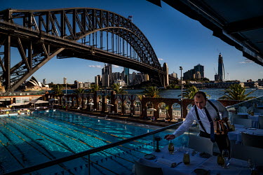 The Aqua Dining restaurant in Milsons Point, near the Sydney Harbour Bridge, is is quieter than usual as many office workers, tourists and locals are keeping away from public areas. ''On a normal Frid...
