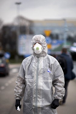 A Polish border and health patrol guard with a protective face mask and hazmat suit as coronavirus containment efforts are enforced on the Oder Bridge, the border crossing between Germany and Poland a...