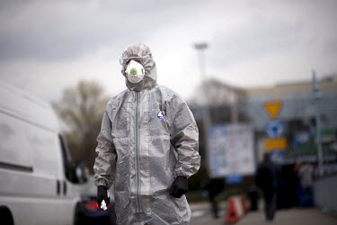 A Polish border and health patrol guard with a protective face mask and hazmat suit as coronavirus containment efforts are enforced on the Oder Bridge, the border crossing between Germany and Poland a...