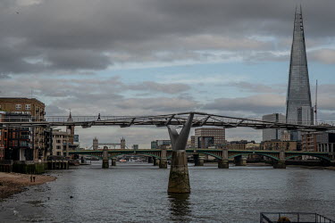 The Millennium Bridge, a pedestrian crossing over the River Thames, stands almost empty as London is locked down in response to the coronavirus. To the right is the Shard and the bridge immediately be...