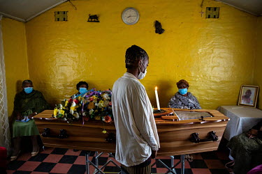 Yule 'Angel' Randles' sister, Alicia (18), takes a final look at his face, visible through his coffin's window, as his family gather for his funeral in Noordgesig.  Angel (32) had been addicted to dru...