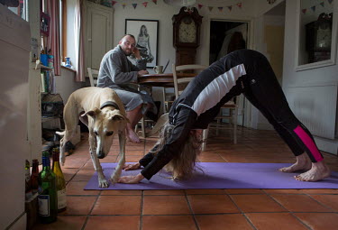 Photographer Tom Pilston and his family are all stuck at home due to the coronavirus lockdown. Tom is documenting the family's experience.  Tom's wife Liz does her morning yoga whilst family dog Jessi...