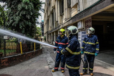 Fire brigade personnel use their equipment to spray disinfectant at civic offices, during the early days of three weeks of complete coronavirus lockdown across India which was announced by Indian Prim...