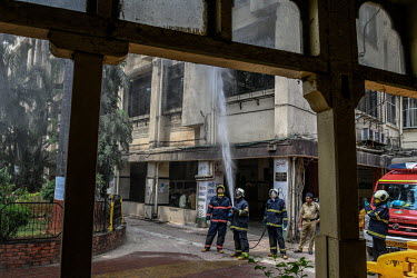 Fire brigade personnel use their equipment to spray disinfectant at civic offices, during the early days of three weeks of complete coronavirus lockdown across India which was announced by Indian Prim...