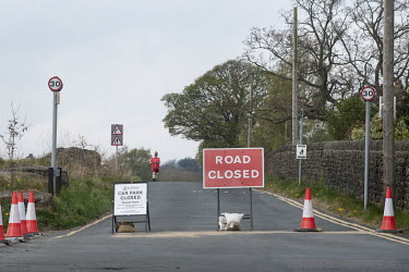 A sign telling people to 'Stay at Home', and barriers barring entry to a road on Shipley Glen, a popular tourist destination near Ilkley Moor. As part of the UK's social distancing and coronavirus loc...