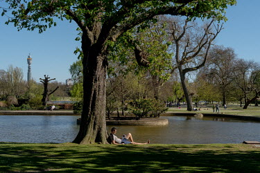 People observe social distancing as they sunbathe in Regents Park. In early April 2020, the Health Minister Matt Hancock, threatened to stop people from exercising outside after reports that many peop...