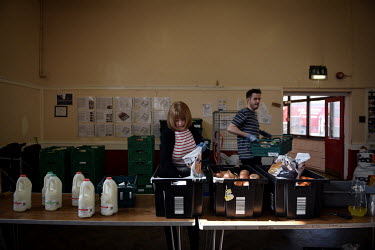 Volunteers Rona Carr and Ryan Gray prepare food parcels for people in need who are attending the Newcastle West End Foodbank. The West End Foodbank feeds more than 3000 people each month and has had t...