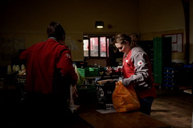 Red Cross workers pick up parcels, to deliver to their clients, at the Newcastle West End Foodbank. The West End Foodbank feeds more than 3000 people each month and has had to adapt its layout and ser...