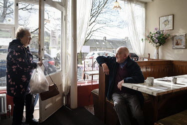 Two elderly people in a cafe where a team of volunteers are delivering food parcels largely to older residents of the town. Rothbury has a significant elderly population but its the community has rall...
