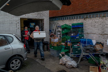 Volunteers cook and pack food that will be distributed to rough sleepers in central London at the headquarters of the Rythms of Life charity. the Government has moved many homeless people into hotels...