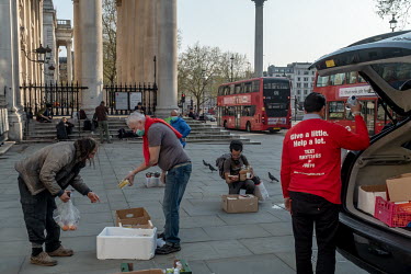 Volunteers from the Rythms of Life charity distribute food to rough sleepers near Trafalgar Square. The government has moved many homeless people into hotels and other accommodation during the pandemi...