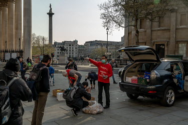 Volunteers from the Rythms of Life charity distribute food to rough sleepers near Trafalgar Square. The government has moved many homeless people into hotels and other accommodation during the pandemi...