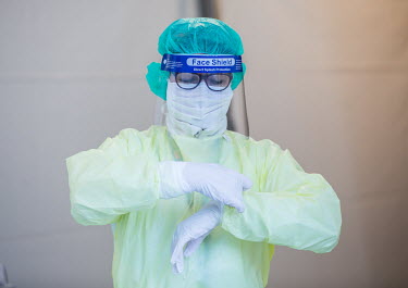 Nurses put on personal protective equipment (PPE) as they prepare to test people for COVID-19, outside Drammen hospital.