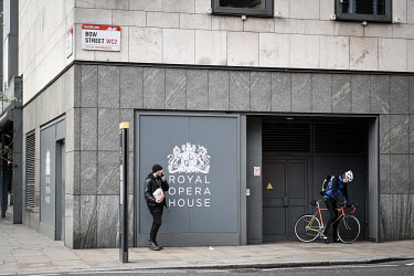Passers by stop outside the Royal Opera House in Covent Garden which has been forced to close its doors due to the Coronovirus outbreak in the United Kingdom. Government advice in the UK continues to...