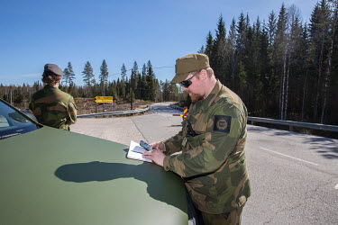 Home Guard soldier Thore Rinden making notes at the closed border with Sweden.