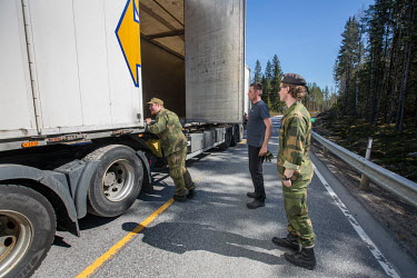 Home Guard soldier Thore Rinden checking a truck, with Kristian Moen looking on at checkpoints leading to the closed border with Sweden.
