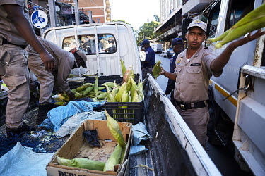 Members of the South African Police Service confiscate goods from illegal street sellers in Hillbrow during the coronavirus lockdown.