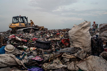 Rubbish pickers search for recyclable plastic and other items amongst a freshly dumped load of waste brought in from Jakarta at the Bantar Gabang landfill.