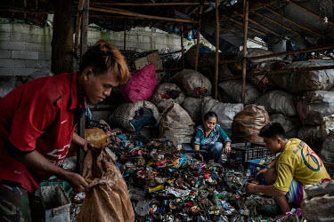 Workers at a small scale recycling business in Ciketing Udik, a village of recyclers and recycling businesses near Bantar Gabang, one of the world's largest landfill sites, sort plastic bottles that h...