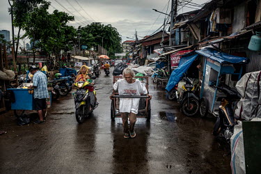 A man pulls a handcart full of household rubbish through the streets of Jakarta. Household waste is collected and dumped at a central point in each neighbourhood and then taken by a dump truck to the...
