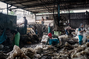 Workers sorting plastic bags at Aneka Plastic, a factory that recycles plastic collected from the Bantar Gabang landfill site. The bags are washed and then manufactured into plastic pellets which are...