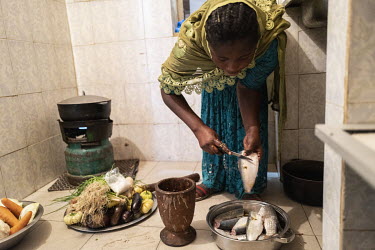 A woman prepares fish and vegetables for her family's evening meal which will break their fast for the first time during Ramadan 2020 which, this year, will be held at home due to the coronavirus lock...