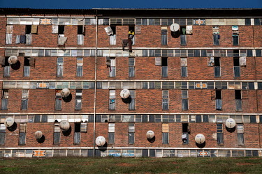 Satellite dishes attached to the exterior of the Madala Hostel in Alexandra Township.