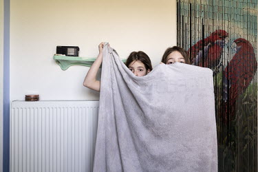 Billie and Suzanne wrap themselves in a towel after taking a bath.  When Belgium followed much of the rest of the world into lockdown, Nick Hannes, like many Panos photographers, found himself unable...