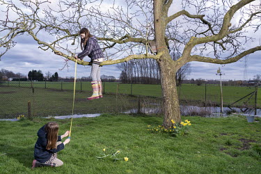 Billie and Suzanne measure the height of the branches of the old walnut tree in their garden.  When Belgium followed much of the rest of the world into lockdown, Nick Hannes, like many Panos photograp...
