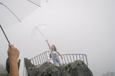 Vietnamese tourists wait for the fog and mist to clear at the top of Ham Rong (Dragon) Mountain.