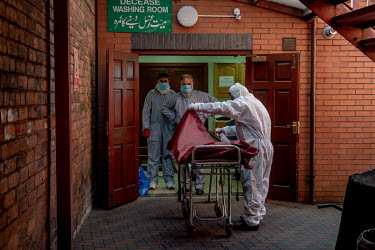 A trolley and bodybag is disinfected after a body was taken for washing at the Ghamkol Sharif Mosque in Small Heath. A temporary mortuary has been set up in the mosque's car park to help the city cope...