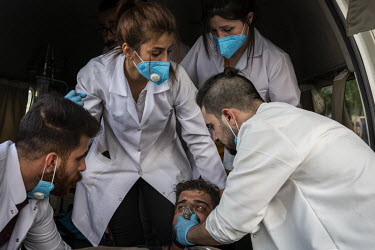 A protester in Tahrir Square is treated by volunteer medical workers for the affects of tear gas, fired by security forces, on the second day of renewed, country wide protests that, since the beginnin...