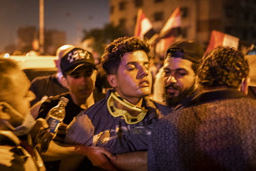 A protester in Tahrir Square is treated for the affects of tear gas, fired by security forces, on the fourth day of renewed, country wide protests that, since the beginning of October 2019, have shake...